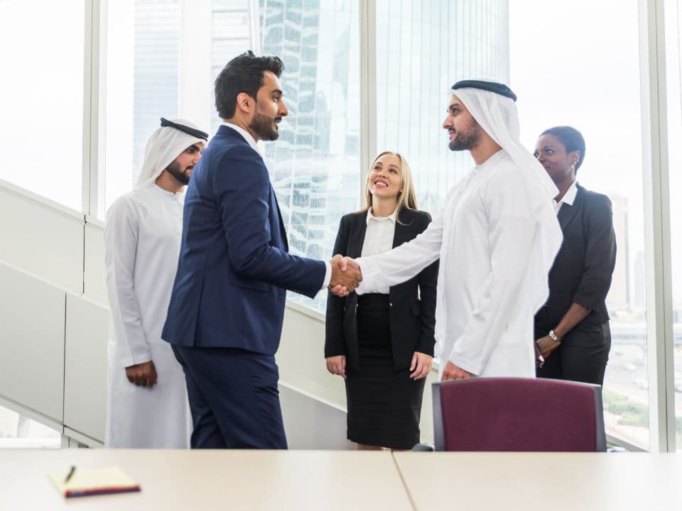 Rukn Al Jada team helping a client in a Dubai office